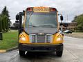 Front view of a yellow 2014 Freightliner B2 school bus with multiple lights on the roof and a large windshield