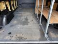 Interior of a 2022 Mercedes-Benz Sprinter van showing a spacious cargo area with a bare floor and metal shelving units on the side