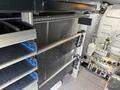 Interior storage system of a 2023 Ford Transit with shelving and compartments for organization
