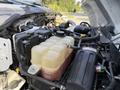 Close-up of the engine compartment of a 2018 Ford F-750 showing the coolant reservoir and various engine components