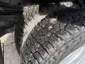 Close-up of two heavy-duty tires from a 2015 Ford F-350 showing deep treads and some dirt on the surface