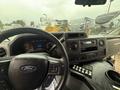 Interior view of a 2021 Ford Econoline showing the steering wheel dashboard and control panel