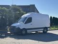 A 2021 Mercedes-Benz Sprinter 2500 van with a white exterior and black accents parked on a driveway