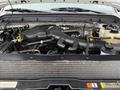 A close-up view of the engine compartment of a 2012 Ford F-550 showing various engine components and hoses
