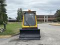 A yellow 2004 Bombardier SW48 snowplow facing forward with a black blade at the front