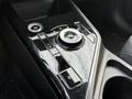 The console of a 2023 Kia Niro EV featuring a circular gear selector dial multiple buttons for drive modes and electronic controls