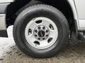 The image shows the wheel of a 2023 GMC Savana featuring a silver rim with a GMC logo and a Michelin tire mounted on it