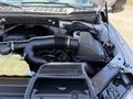 A close-up view of the engine compartment of a 2018 Ford F-150 highlighting the air intake and fluid reservoir