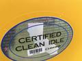 A yellow sticker displaying the text "CERTIFIED CLEAN IDLE" with the Hino logo and a barcode beneath it