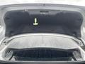 Trunk space of a 2018 Ford Focus with an open lid showing the inside of the trunk and the rear windshield reflecting raindrops