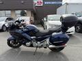 A 2016 Yamaha FJR1300AE motorcycle in dark blue with a large rear trunk and sleek design parked on a lot