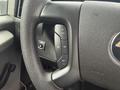 Steering wheel controls of a 2013 Chevrolet Express including buttons for cruise control and settings