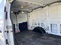 Interior view of a 2017 Ford Transit van showcasing a spacious cargo area with empty walls and floor without any shelving or cargo installed