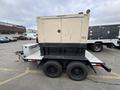 A 2005 Katolight SED60FPJ4 generator on a trailer with a dark base and a beige enclosure featuring a closed door and a small hitch on the front