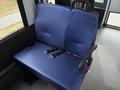 A blue patterned seat with seat belts designed for a 2020 Chevrolet Express van