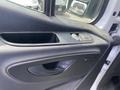 Close-up of the door panel of a 2024 Mercedes-Benz Sprinter featuring window controls and a door handle