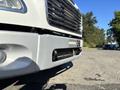 A 2006 Freightliner M2 106 truck with a silver front bumper and black grille visible in the foreground