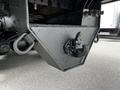 Close-up of a heavy-duty towing hitch mounted on a 2011 International 4400 truck featuring a triangular design and a hook for securing trailers