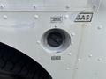 Close-up of a gas filler with a cap and labels indicating unleaded fuel only on a 2011 Workhorse W62 vehicle