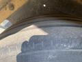 Close-up of the tire of a 2010 Vermeer Corporation BC1200XL featuring a worn tread pattern and visible sidewall markings