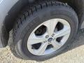Close-up of a 2014 Ford Escape wheel and tire showing silver alloy rim and tread pattern on the tire