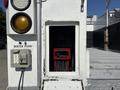 Water pump compartment of a 2011 Ford F-550 with a red pump inside and electrical outlets mounted on the side