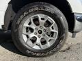 Close-up of a silver alloy wheel with a Goodyear Wrangler tire on a 2021 Ford F-150