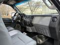 Interior view of a 2015 Ford F-350 showing a gray dashboard with controls and seating designed for heavy-duty use