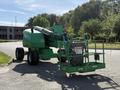 A 2015 JLG 450AJ articulated boom lift in green with a platform and wheels ready for operation