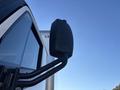 A black side mirror of a 2022 Lion Lion6 vehicle angled outward
