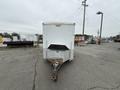 A 2016 Continental cargo trailer with a white exterior and a front ramp door featuring a metal hitch and reflective striping