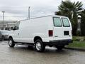 White 2006 Ford Econoline van parked with rear doors closed and no visible branding
