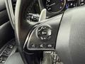 A close-up view of the steering wheel controls in a 2016 Mitsubishi Outlander showing buttons for audio mode phone and various settings