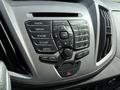 Dashboard controls of a 2016 Ford Transit featuring buttons for radio media phone sound and a central navigation dial
