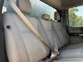 The interior seating of a 2019 Ford F-550 featuring gray fabric upholstery with three rear seats and seatbelts