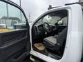 A 2011 Dodge Ram 5500 with a partially open driver's door revealing the interior including the seats dashboard and steering wheel