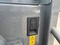 Close-up of a control panel featuring a switch and a caution symbol on a 2014 Wacker Neuson WL34 machine
