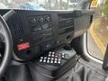 Interior dashboard of a 2020 Chevrolet Express featuring a radio, climate controls, and a series of buttons on the center console