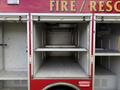 A 2007 Ford F-550 with open storage compartments designed for fire and rescue equipment featuring empty shelves inside