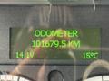 A digital odometer display showing a reading of 101679.5 kilometers with battery voltage of 14.1V and temperature of 15°C