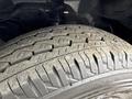 Close-up of the tire tread on a 2009 Toyota Hiace showing a worn pattern with distinct grooves and bumps designed for traction