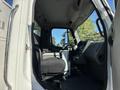 Interior view of a 2006 Freightliner M2 106 truck showcasing the driver's seat dashboard and steering wheel