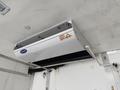 A white Carrier refrigeration unit mounted on the ceiling of a truck's cargo area