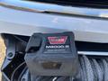 A WARN M8000-S contactor control unit mounted on a cable winch attached to a 2017 Chevrolet Colorado