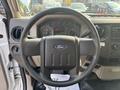 Steering wheel of a 2009 Ford F-550 with dashboard instruments visible behind it
