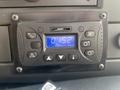 Dashboard control panel of a 2020 Chevrolet Express featuring buttons for various functions and a digital display showing time