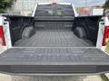 A 2017 Ford F-150 truck bed with a black spray-in liner and no cargo inside