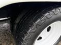 Close-up of a 2017 Ford E450 tire featuring a textured tread pattern and a white rim