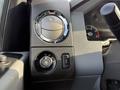 Close-up view of a 2015 Ford F-550 dashboard control panel featuring a large circular air vent control and toggle switch for headlight settings