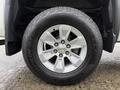 A silver alloy wheel with a five-spoke design mounted on a black Pirelli Scorpion tire on a 2015 GMC Sierra 1500